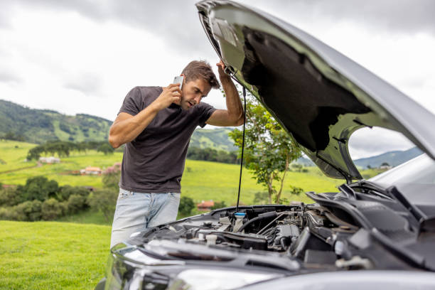 Man checking engine breakdown and calling for car towing Melbourne service