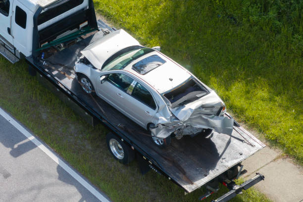 Crashed silver car transported on flatbed tow truck Melbourne accident recovery