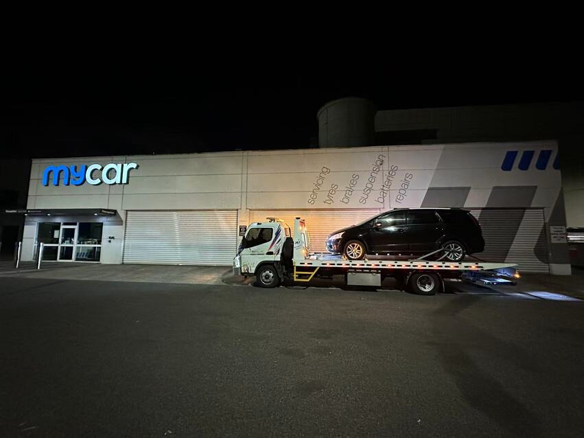 Towing Clayton – tow truck delivering black car to Mycar service centre at night