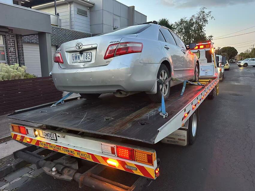 Towing Clayton – silver Toyota sedan on flatbed tow truck in residential area