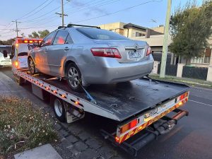 Silver Toyota Camry secured on a flatbed tow truck in Melbourne