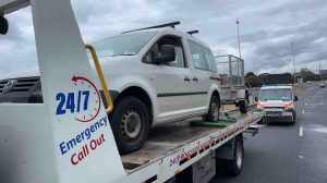 Maningham Towing tow truck loading a broken down van on the freeway during a 24/7 car towing Melbourne emergency service