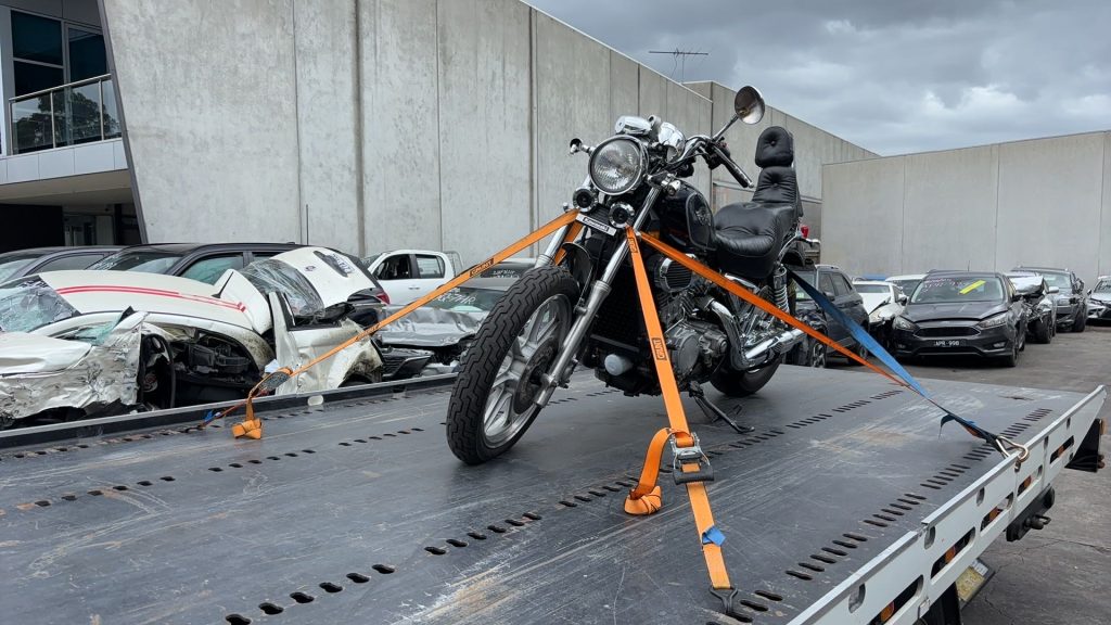 Motorcycle secured with straps on a flatbed tow truck for safe motorcycle towing in Melbourne