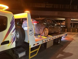 24/7 tow truck loading a damaged car at night in Melbourne roadside recovery
