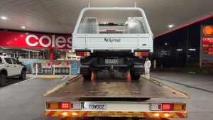 Utility vehicle loaded onto a flatbed tow truck for night-time vehicle recovery in Melbourne