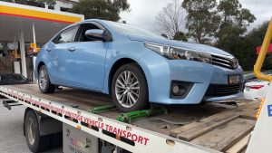 Car secured on a flatbed tow truck in Melbourne